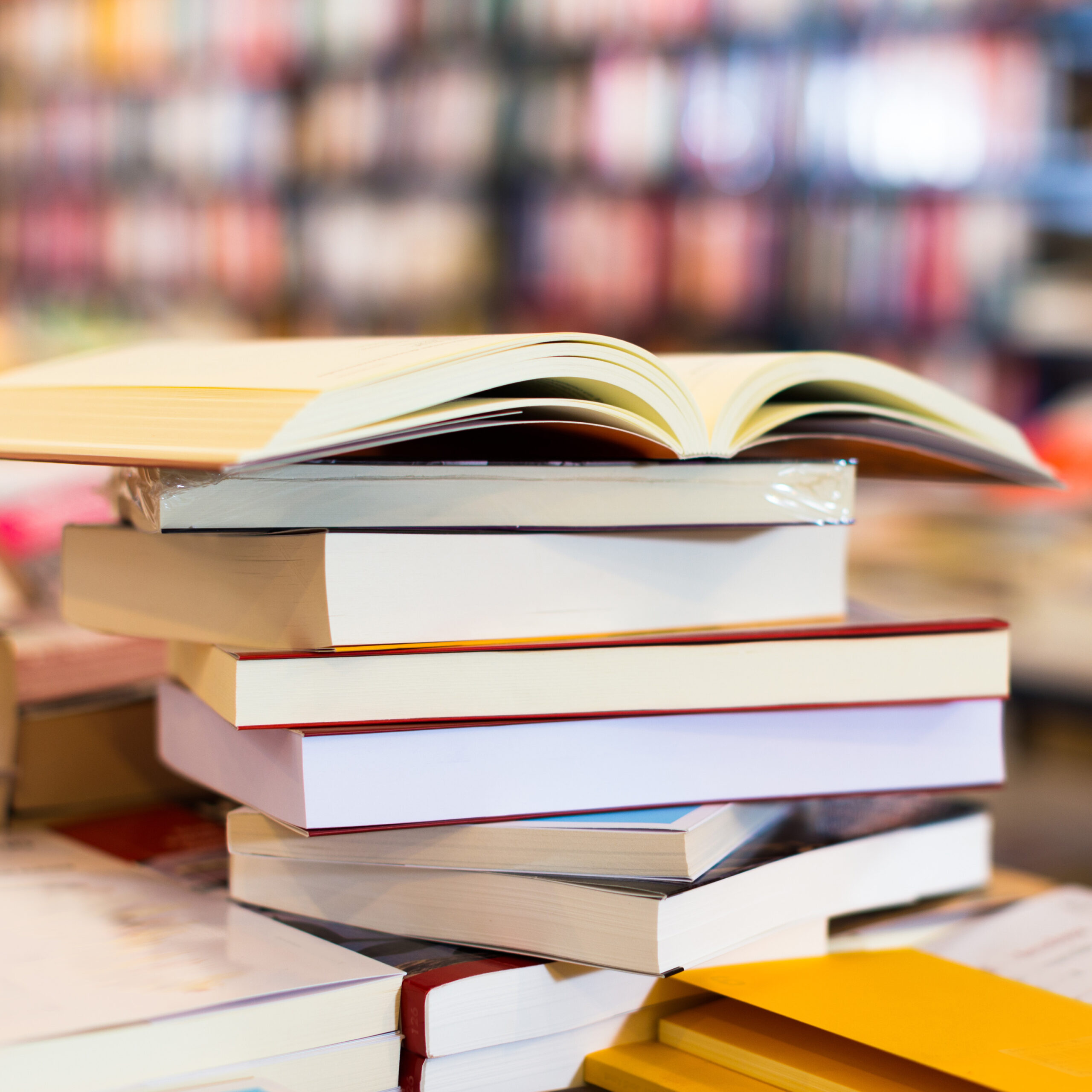 stack of books lying on table in bookstore black and white books